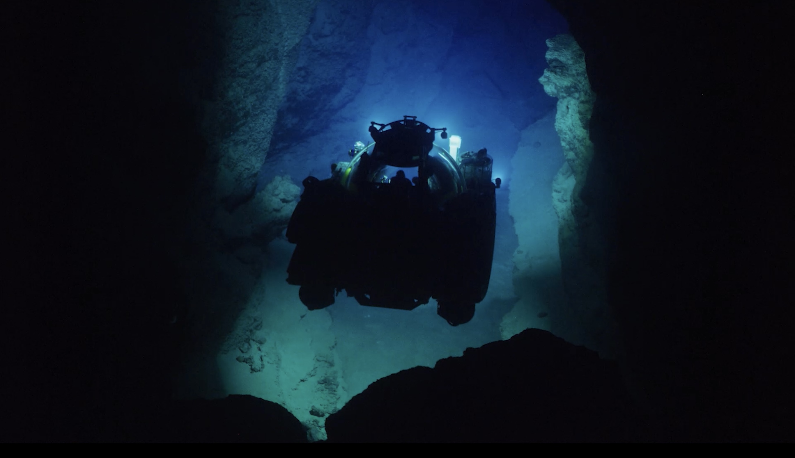 Submersible moving through a dark underwater cave